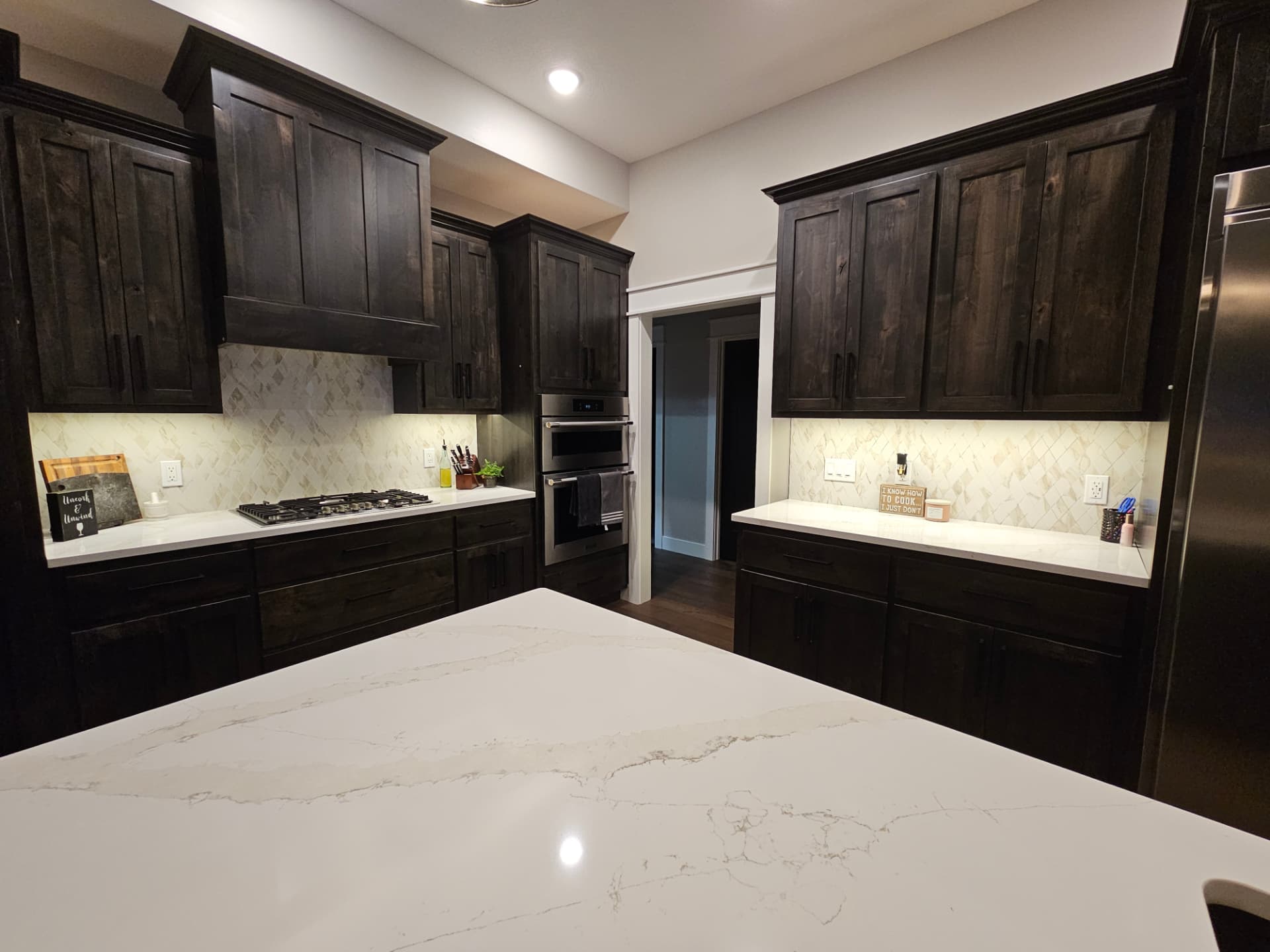 Custom kitchen with built-in cabinetry, detailed trim work and quartz countertops in a Midwest Custom Homes home.