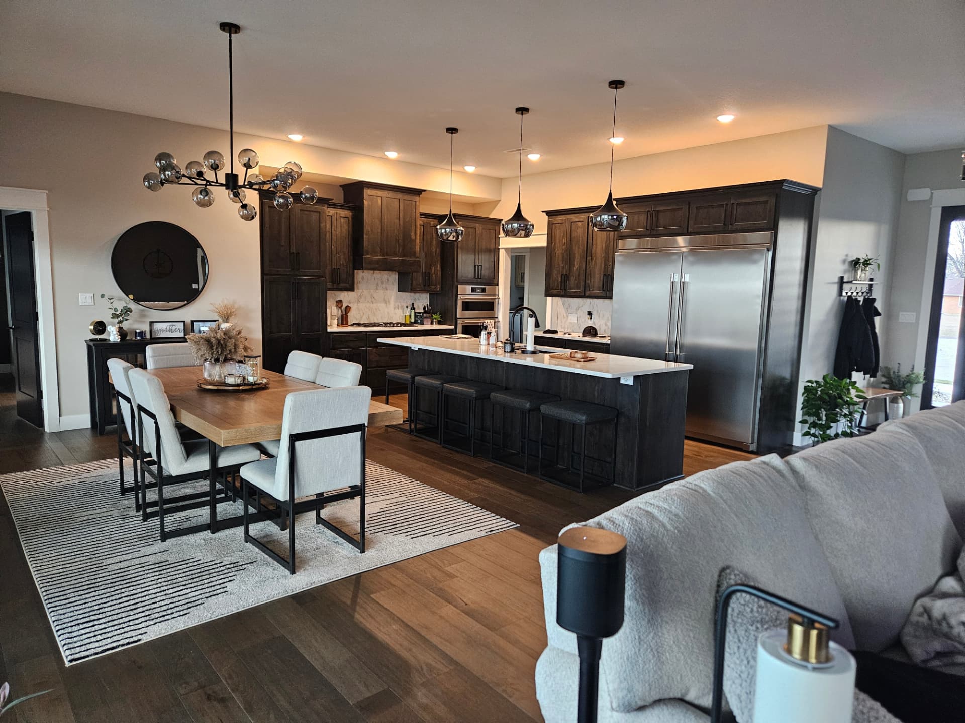 Custom kitchen with dark wood cabinetry, quartz countertops and built-in appliances in a Midwest Custom Homes home.