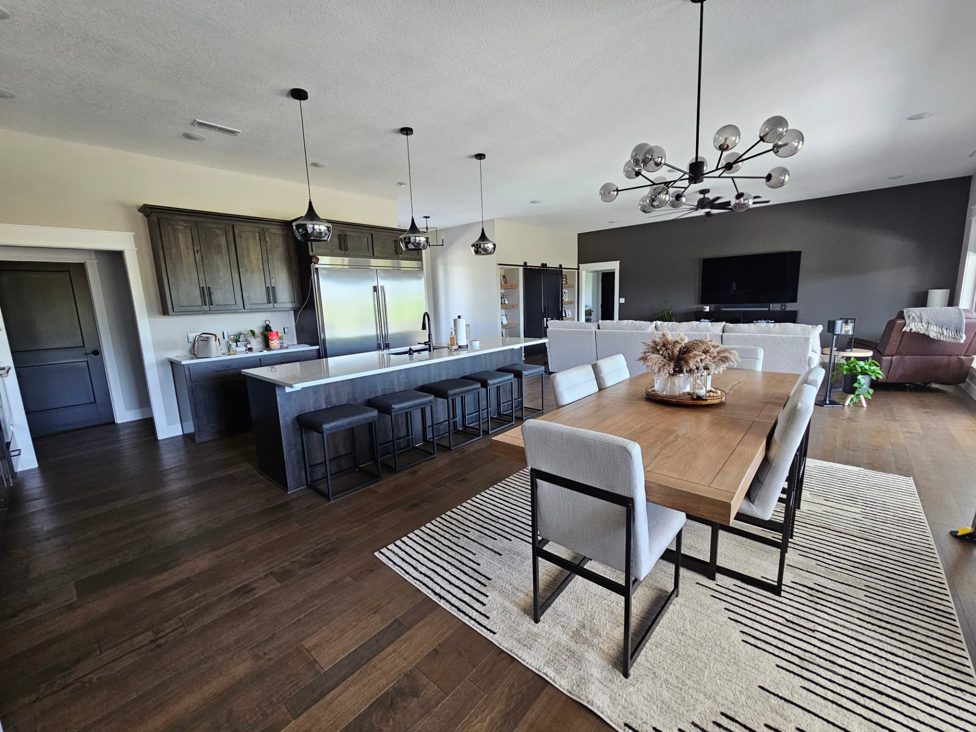 Open-concept kitchen, dining and living area in a Midwest Custom Homes custom home.
